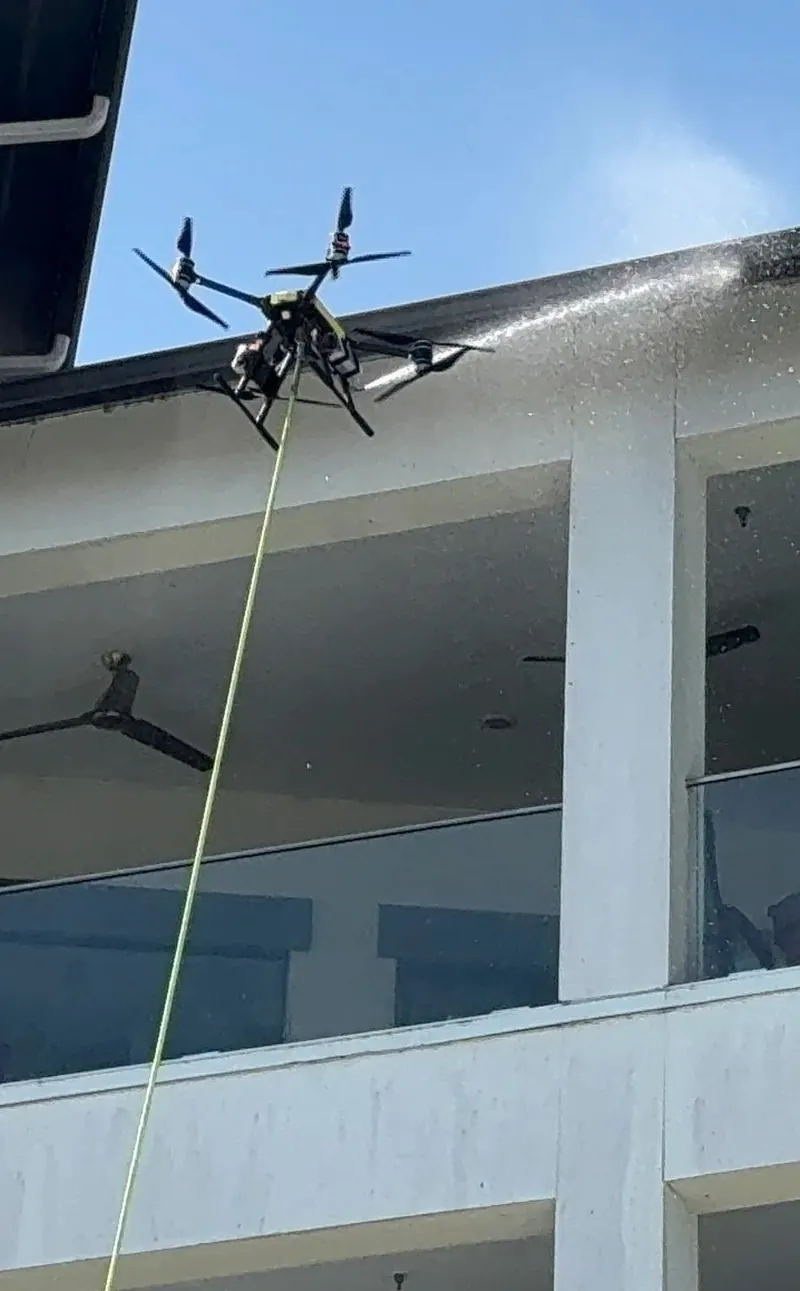 Drone washing the balconies of a condominium complex